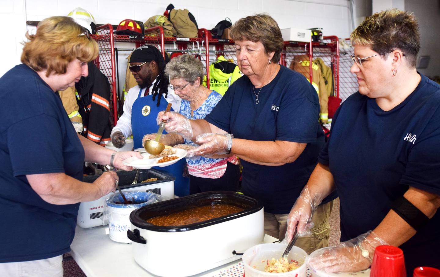 Members of the Order of the Eastern Star serve meals to fellow members and staff at the Newton Fire Department on Aug. 28 at the local fire station. The fraternal organization wanted to show its support for firefighters and paramedics at Newton Fire Department by providing a free meal and a $100 check for the SAFE House Program.