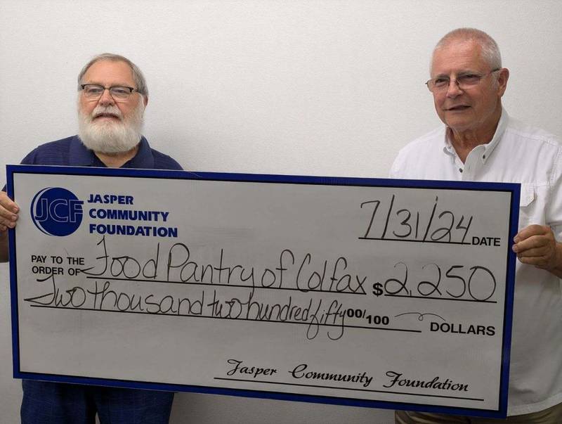 Bob Corbitt accepts a check in the amount of $2,250 from Dan Skokan of the Jasper Community Foundation.