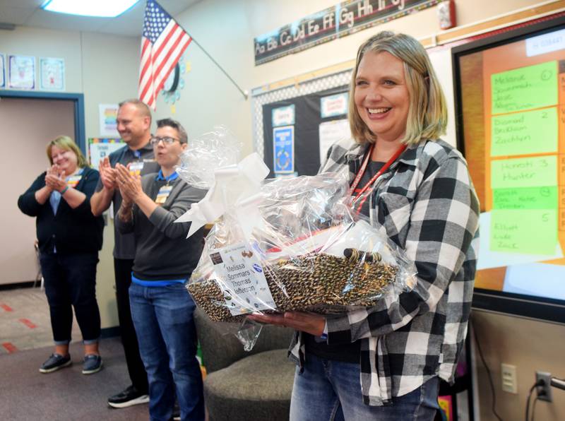 Teacher Melissa Sommars of Thomas Jefferson Elementary School receives a gift basket from Walmart and other local businesses who wanted honor teachers for all their work.