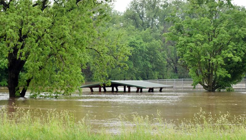 Only the roof of the shelter in Holmdahl Park can be seen during the May 21 floods in Kellogg. A month after the president issued a disaster order for a number of Iowa counties affected by storm damage and floods, Jasper County and two other counties were added to the declaration.