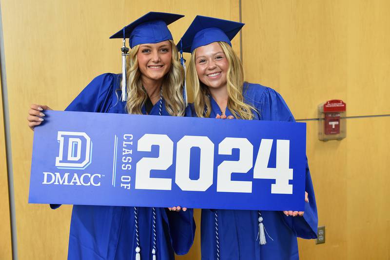 Nicole Bunse of Baxter, left, and Evie Main of Newton, were among more than 1,000 student smiling for cameras before the 2024 DMACC Metro Commencement Ceremony at Wells Fargo Arena in Des Moines.