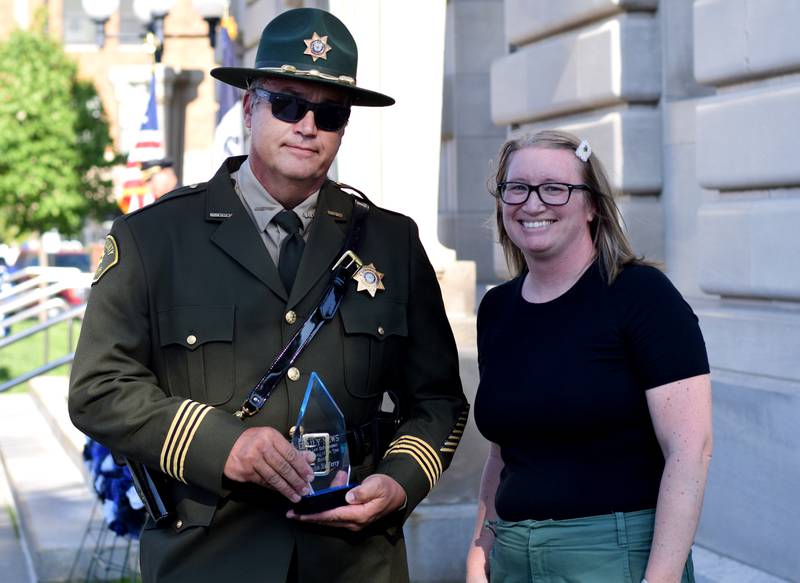 Jasper County Sheriff John Halferty accepts the Law Enforcement Employee of the Year from Newton News Editor Jamee A. Pierson during National Police Week Ceremony held May 16 outside the Jasper County Courthouse. Officers, dispatchers and jailers participated in the ceremony, which honors the six local individuals who died on active duty or in the line of duty.