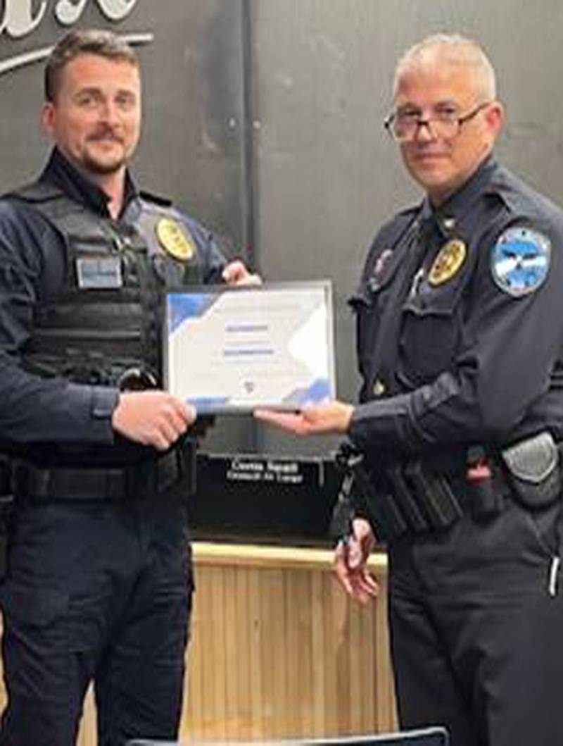 Officer Gabe Wilson accepts certificate from Colfax Police Chief Jeremy Burdess.