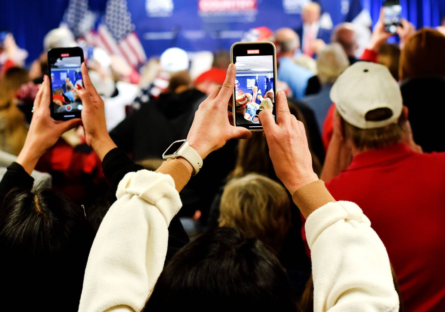 Supporters take pictures of former president Donald Trump during a Jan. 6 commit-to-caucus rally in at the DMACC Newton Campus.