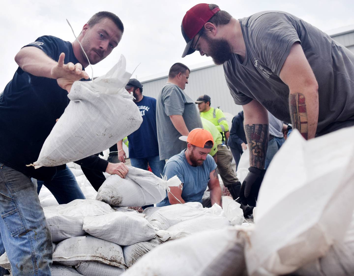 Volunteers on May 21 haul sandbags to be used in areas of Kellogg after the town had been hit with severe flooding, the waters of which had completely covered Holmdahl park, compromised a lift station and overflowed onto Iowa Highway 224, the road that leads into town.