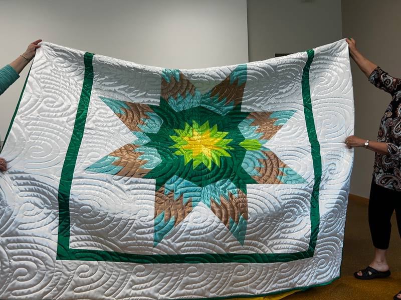 Sharon Falck was gifted this Morningstar quilt by Lakota quilters to thank her for her work with them.