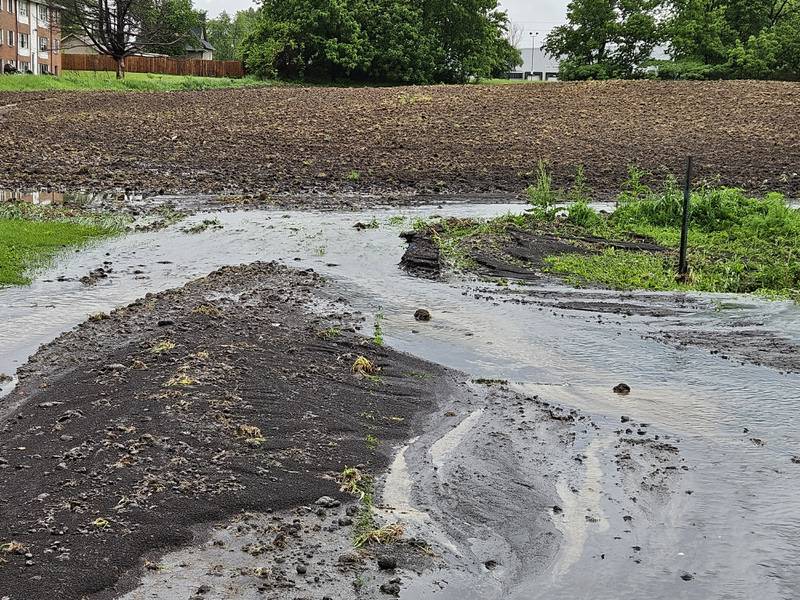 Topsoil runoff affected nearby neighbors during the May 21 floods. The city alleges the runoff occured because the field's property owners did not install erosion control.