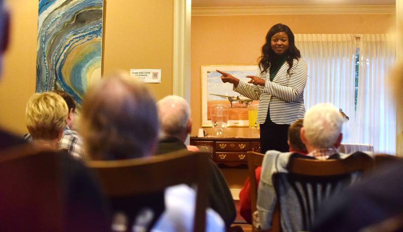 Deidre DeJear, the Democratic candidate running for governor, speaks with guests during a meet-and-greet on Oct. 12 in Newton.