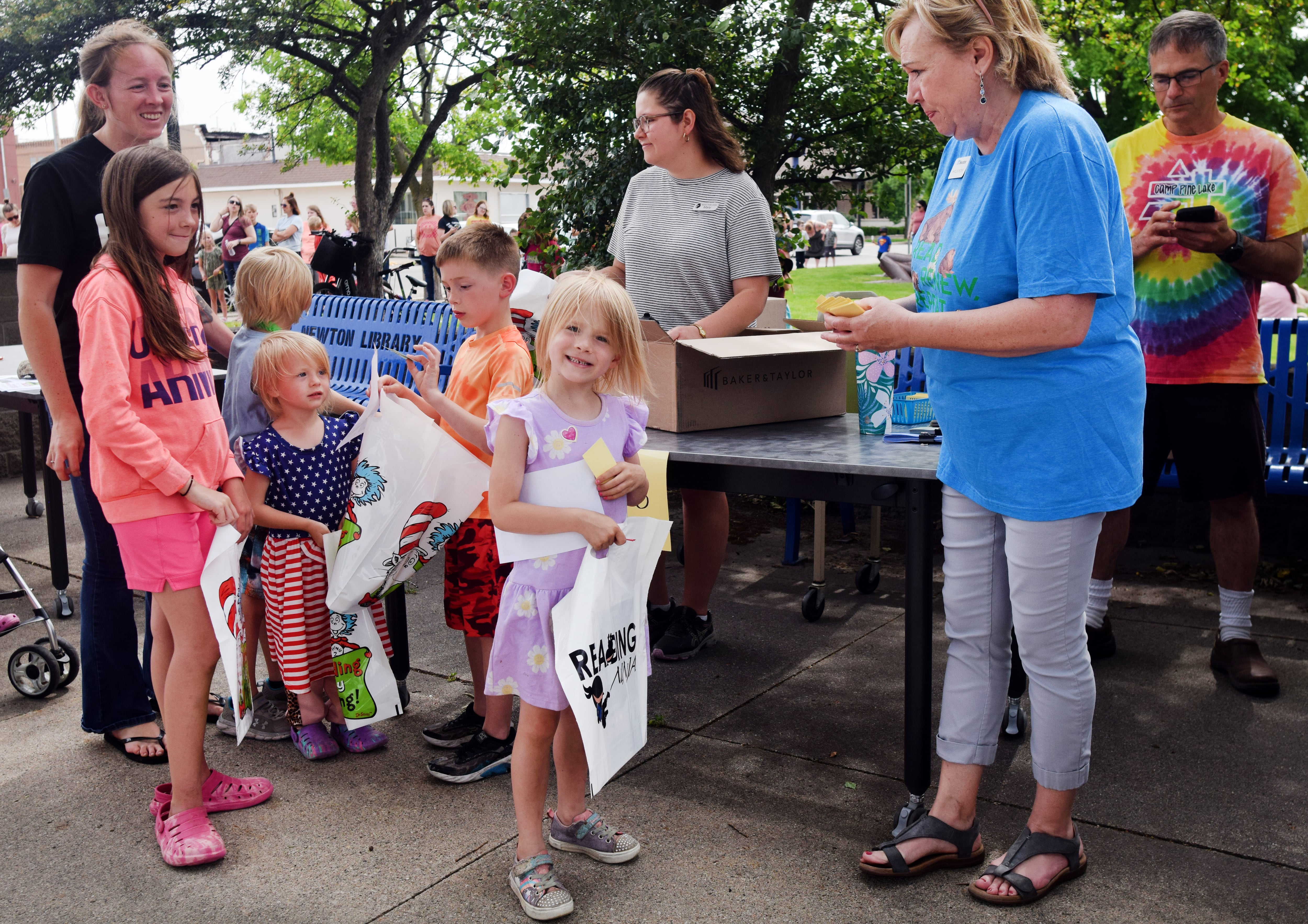 Families and children sign up for the Newton Public Library's summer reading program during its kickoff party in May on the library lawn. In total, the library recorded more than 800 registrations for the program, the most it has ever seen.