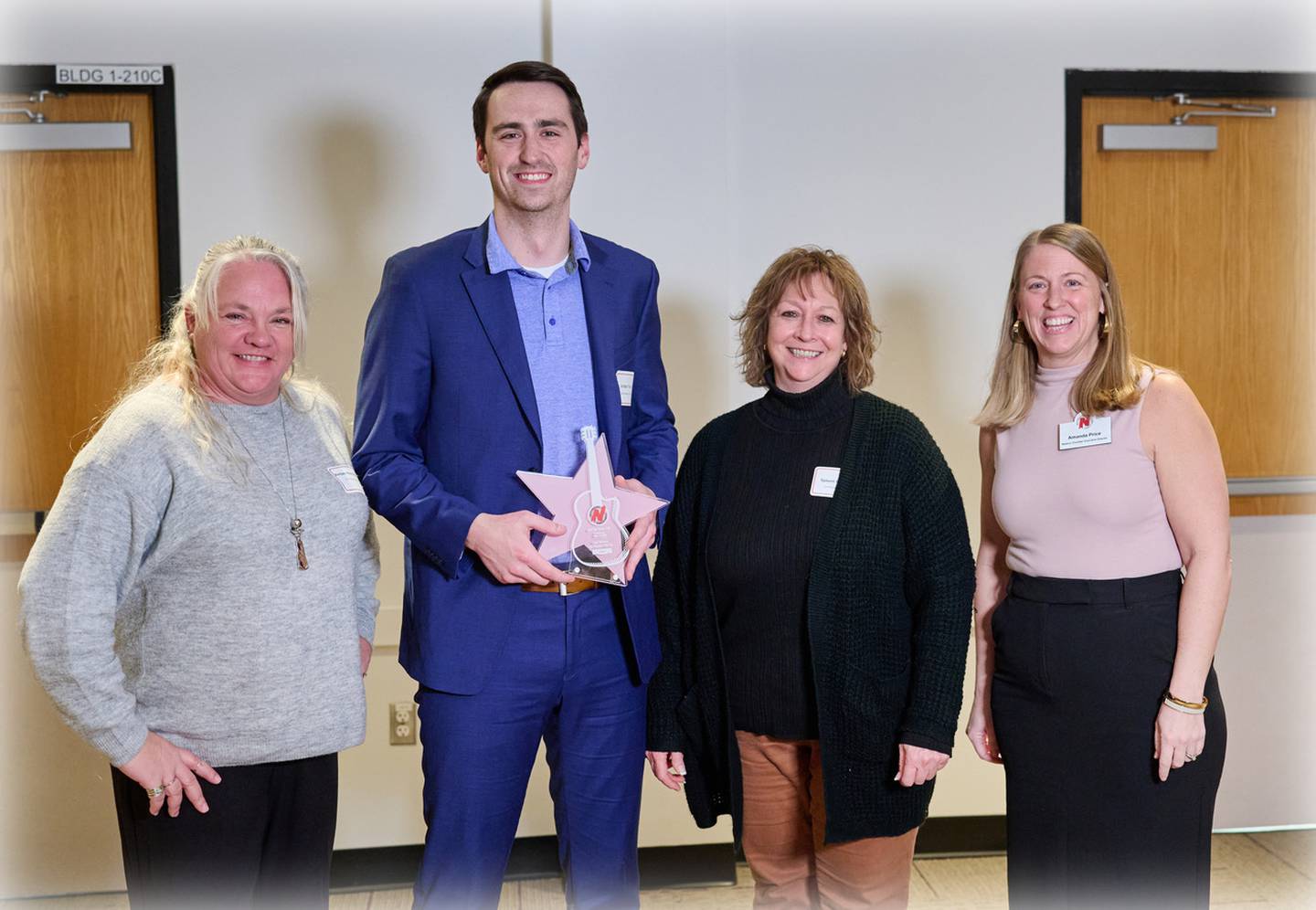 Representatives of Van Maanen Electric, Inc. receive the Community Rock Star Award for a large business from Greater Newton Area Chamber of Commerce Executive Director Amanda Price during the 125th Annual Meeting and Awards Dinner on Jan. 18 at the DMACC Newton Campus Conference Center. Photo by John Lee Photography.