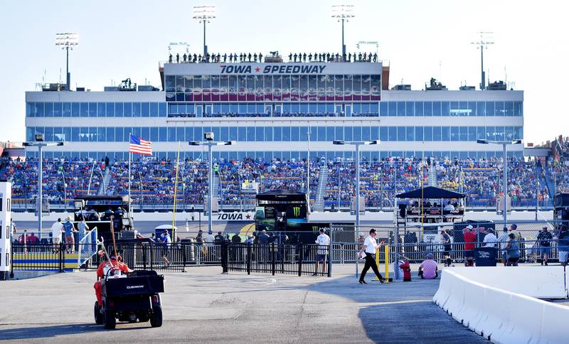 Racing staff and media scatter along the infield during the NASCAR Cup Series Iowa Corn 350 on June 16 at the Iowa Speedway in Newton. It was the first ever Cup Series race to be held on the short track designed by Rusty Wallace.