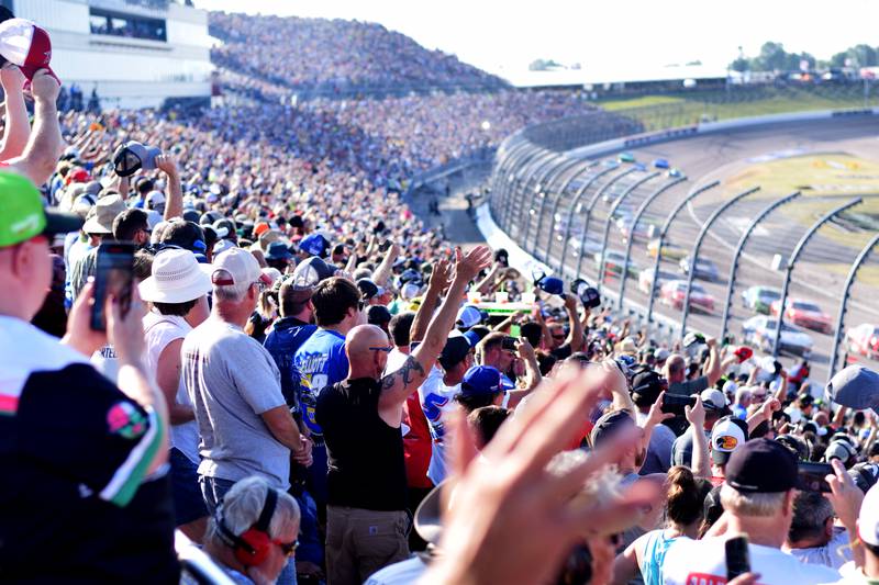 Race fans cheer on their drivers just before the NASCAR Cup Series Iowa Corn 350 race on June 16 at the Iowa Speedway in Newton.