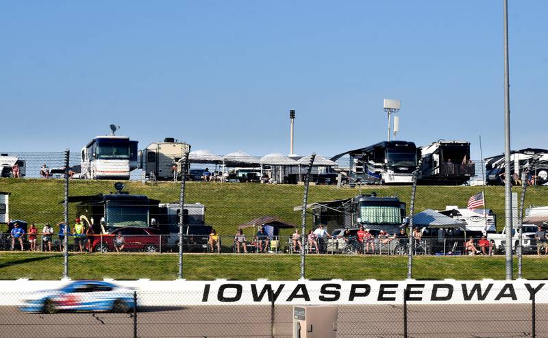 Those who found camping spots near the track watch the cars fly by during the NASCAR Cup Series Iowa Corn 350 race on June 16 at the Iowa Speedway in Newton.