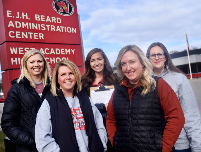 From left: Kyla Knudson, Jess Rother, Jennifer Parsons, Jackie Carson and Elizabeth Richardson pose for a picture outside the E.J.H. Beard Administration Center in Newton. The group has organized two petitions arguing against the school board's configuration decision. To sign either of the petitions, the group says to visit Murph & Mary's Pub or Book Trader Tan America or email the group at ncsdpetition@gmail.com.