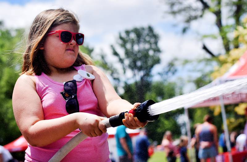 Kids participate in obstacle courses and take a try at the fire hose during Safety Fest on June 8 in Maytag Park. Safety Fest is regularly organized by the Newton Fire Department.