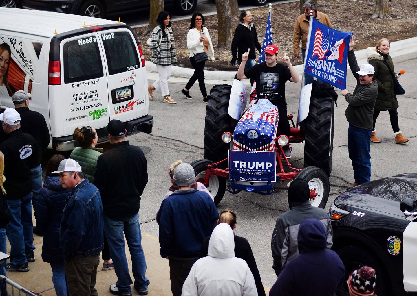 Supporters of Donald Trump take pictures on Gary Leffler's patriotic tractor before a Jan. 6 rally at DMACC Newton Campus.