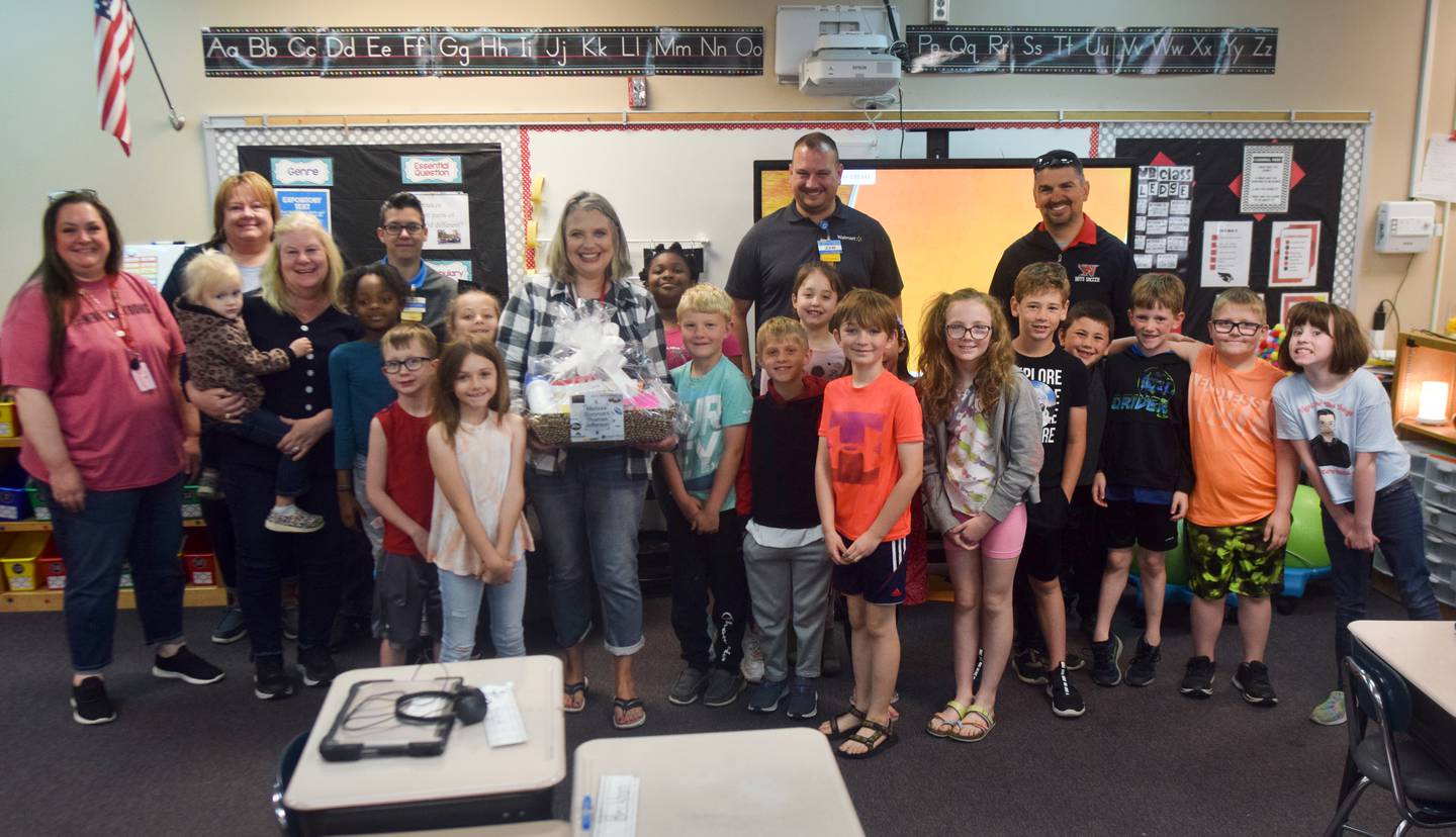 Teacher Melissa Sommars of Thomas Jefferson Elementary School poses with her class and  employees of Walmart and other local businesses who wanted to honor teachers with gift baskets as a sign of appreciation.