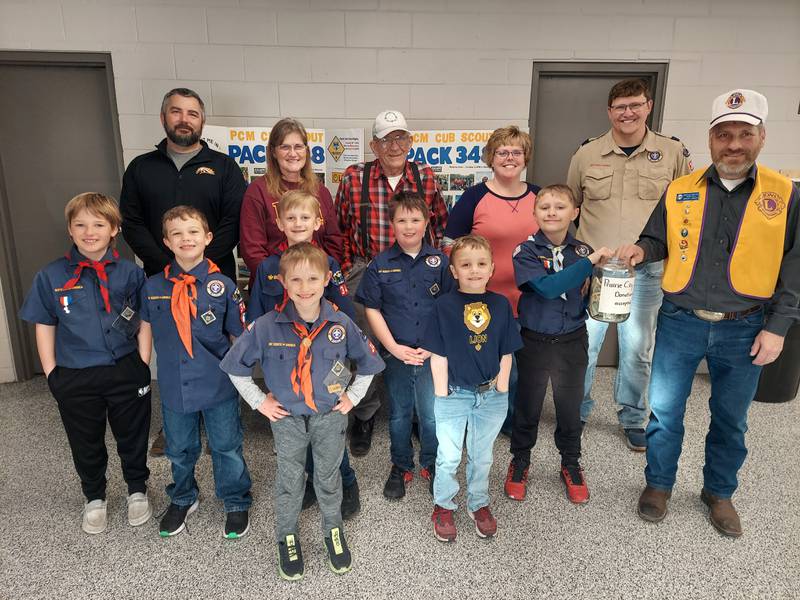Lions Club President Greg Townley and Cub Scouts from PCM Cub Scout Pack 348 are shown with donations received at the Pancake Breakfast March 23.  Lions Club members in the back row are John Buys, Janet Townley, Arnie Sohn and Shonna Ellis along with Scout Master Ross Baxter.