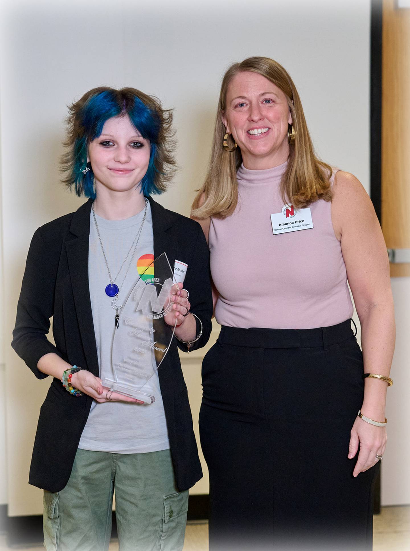 Lucy Eckert of Lucy's Pet Pantry receives the Community Service Award from Greater Newton Area Chamber of Commerce Executive Director Amanda Price during the 125th Annual Meeting and Awards Dinner on Jan. 18 at the DMACC Newton Campus Conference Center. Photo by John Lee Photography.