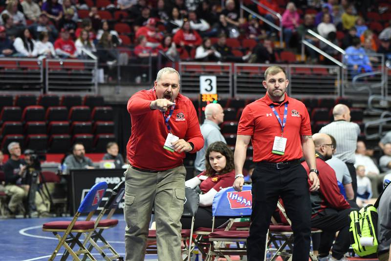 Assistant coach Jeff Richardson and head coach RJ Brown of Newton's wrestling team interact with players during a match. Newton Activities and Athletics Director Ryan Rump told school board members on July 8 that some school sports are in need of extra coaches on staff.