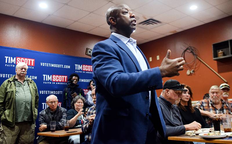 U.S. Sen. Tim Scott, a Republican presidential candidate, speaks with potential voters at a campaign stop Oct. 12 at the Pizza Ranch in Newton.