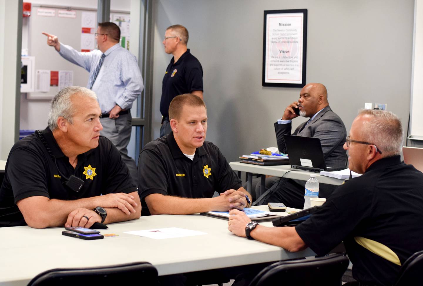 Members of the Jasper County Sheriff's Office talk amongst themselves June 9 before participating in a threat assessment training session at E.J.H. Beard Administration Center in Newton.