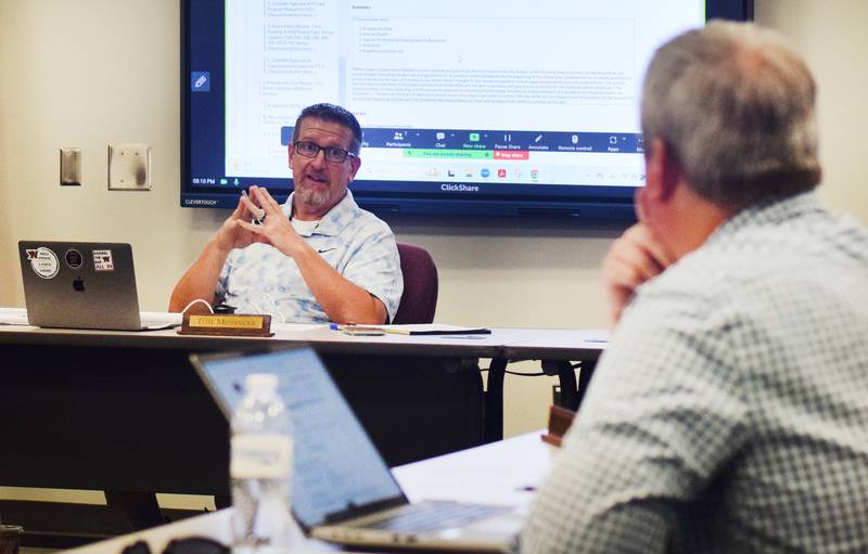 Newton Superintendent Tom Messinger speaks with school board members about the resolution he drafted that would make holding lawmakers responsible the district's No. 1 legislative priority.