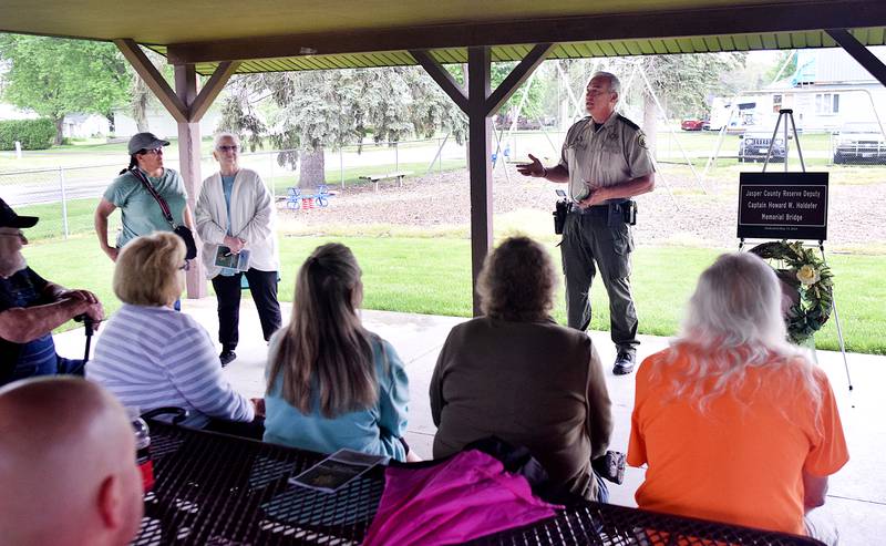 Jasper County Sheriff John Halferty speaks to Howard Holdefer's family during a dedication ceremony May 13 at the city park in Reasnor.
