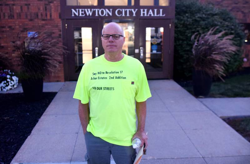 Mark Vickroy, of Newton, wears a custom T-shirt opposing the approval of the second addition of Arbor Estates on Sept. 18 outside Newton City Hall.